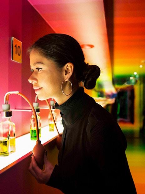 Visitor exploring scent bottles at Bols Cocktail Experience, Amsterdam.