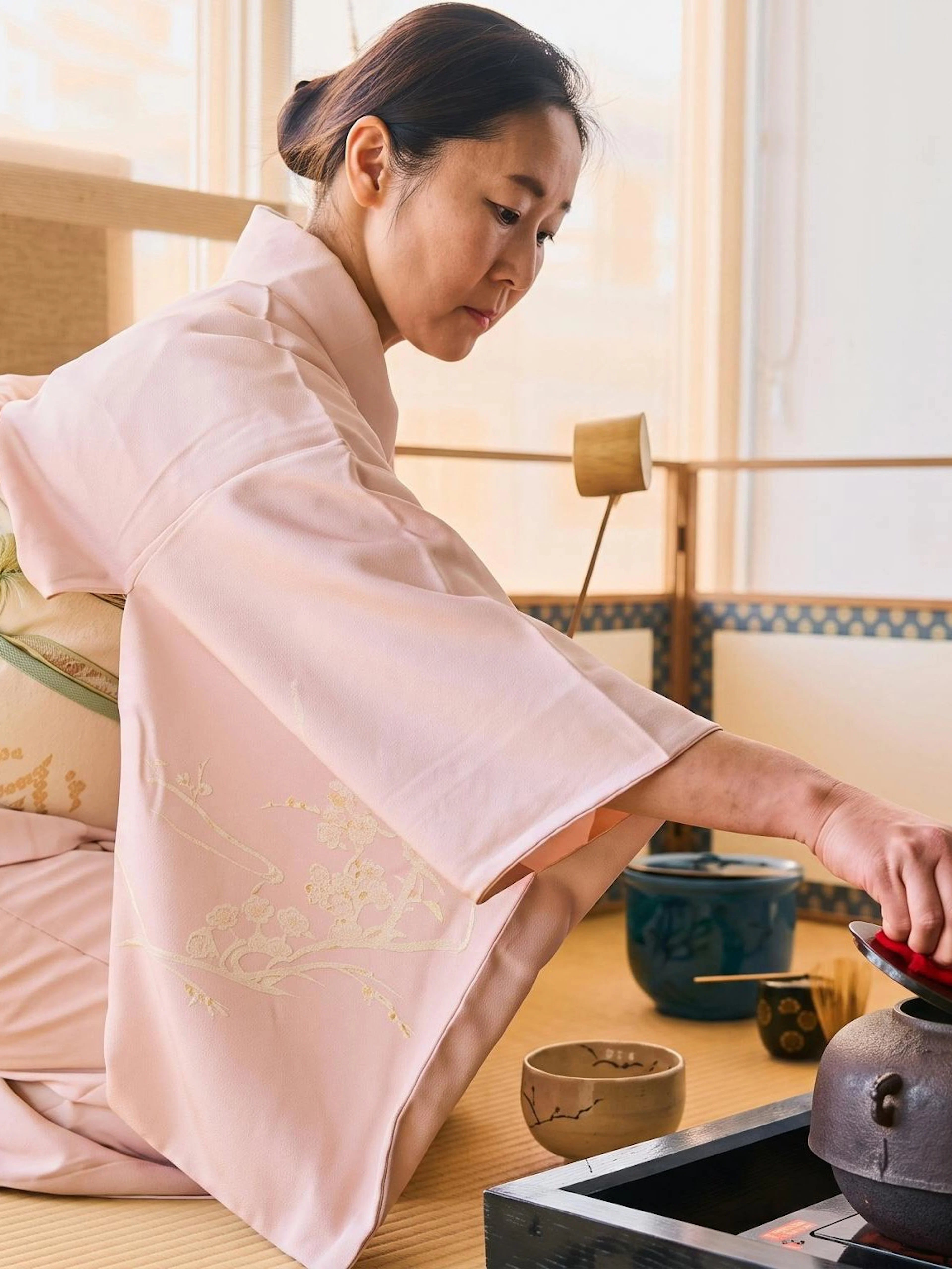 Lady performing tea ceremony in Tokyo, Japan, wearing traditional kimono.