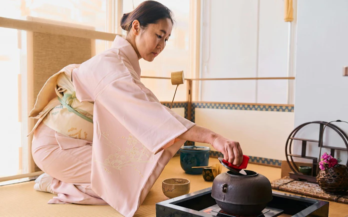 Lady performing tea ceremony in Tokyo, Japan, wearing traditional kimono.