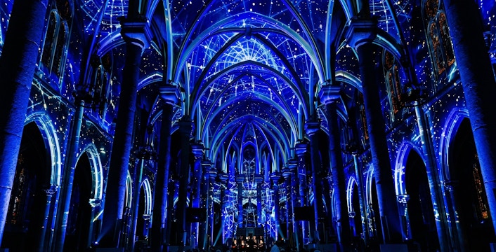 360° projection concert at Westminster Cathedral, London, with blue celestial visuals.