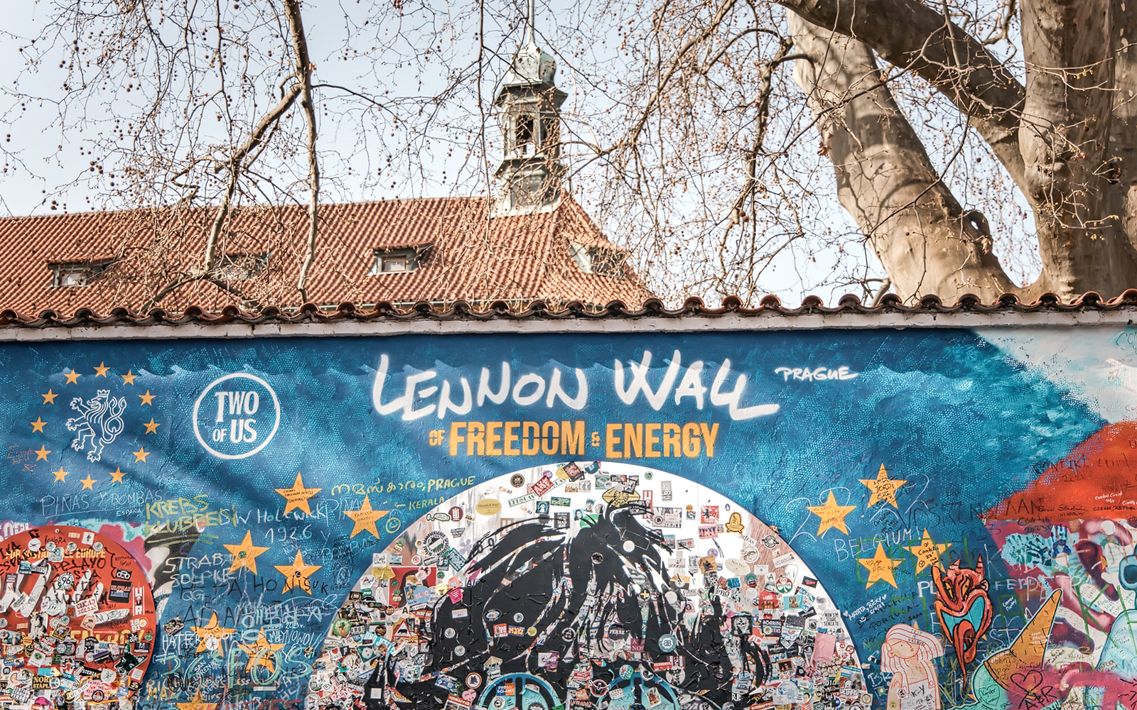Lennon Wall in Prague with colorful graffiti and messages, part of the Prague Old Town tour.
