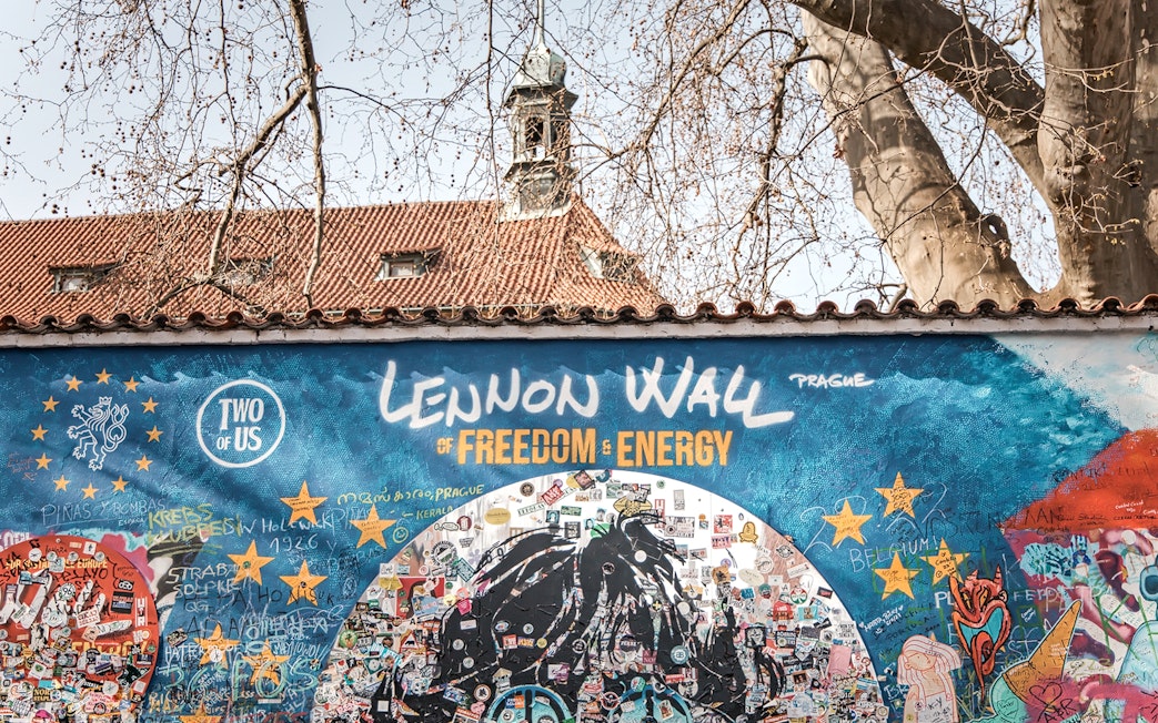 Lennon Wall in Prague with colorful graffiti and messages, part of the Prague Old Town tour.