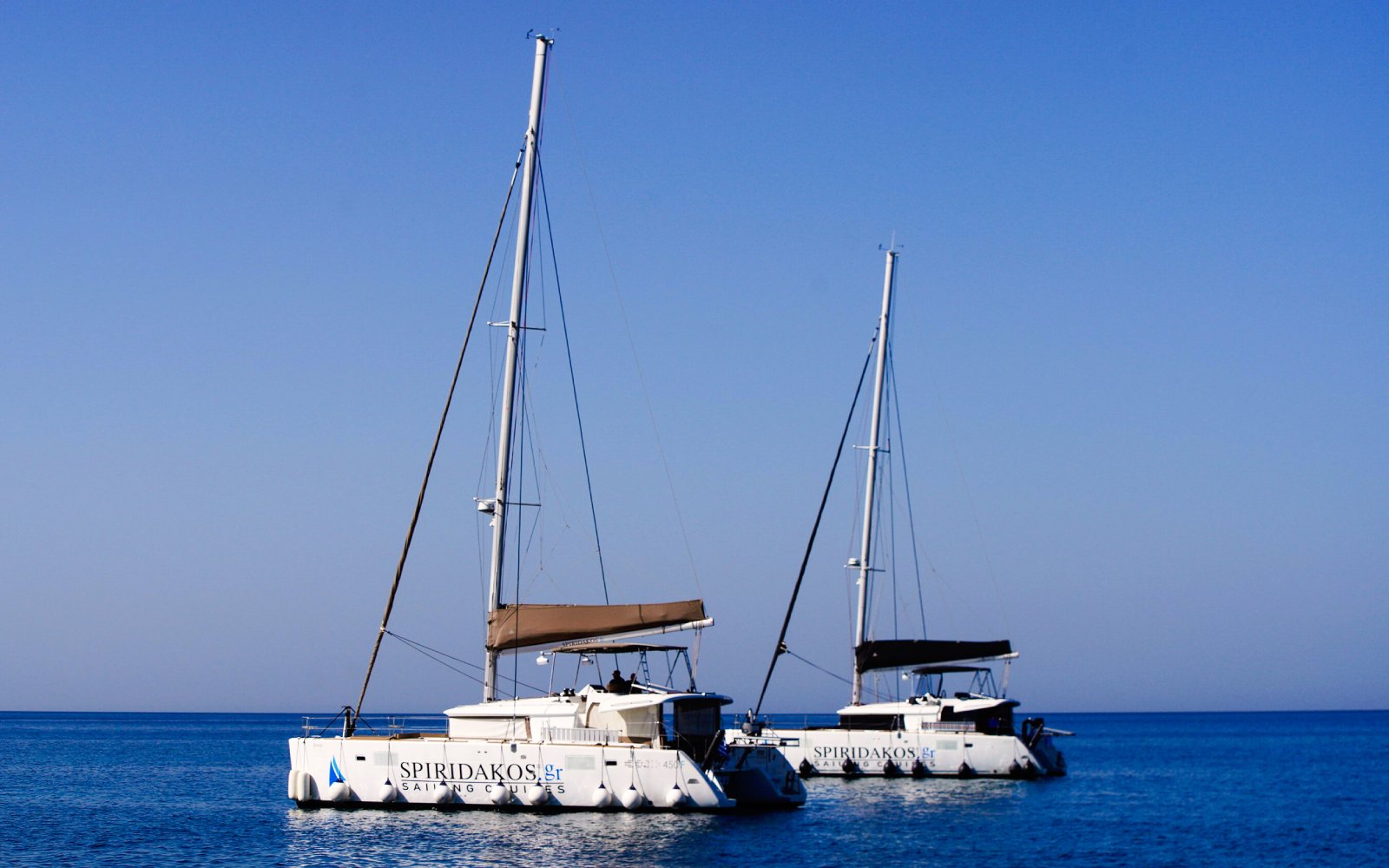 Catamarans on the water during a Classic Catamaran Cruise in Santorini.