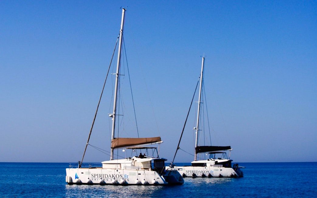 Catamarans on the water during a Classic Catamaran Cruise in Santorini.