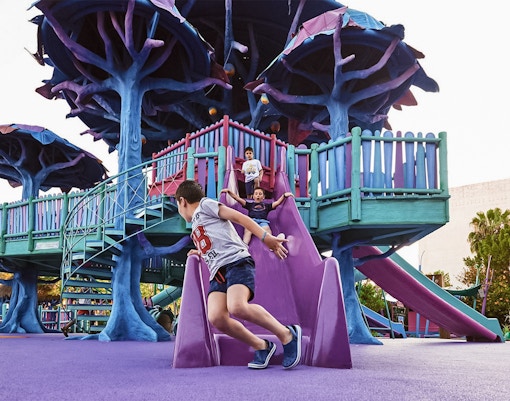 Children enjoying a ride at Fountain of Youth, Isla Mágica, Seville.