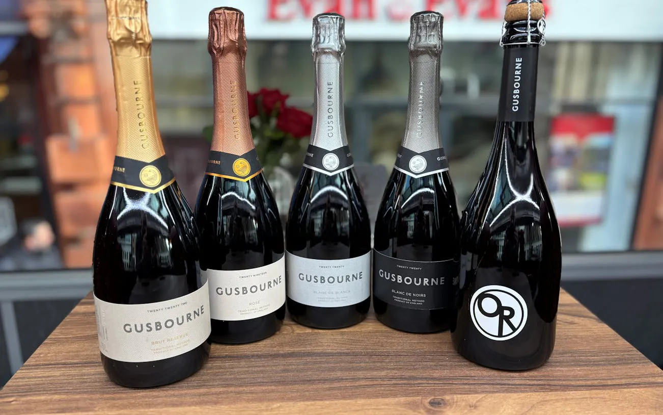 Gusbourne sparkling wine bottles displayed for London sightseeing tour with wine and cheese tasting.