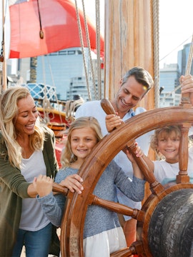 Family enjoying interactive exhibit at Sydney's National Maritime Museum.