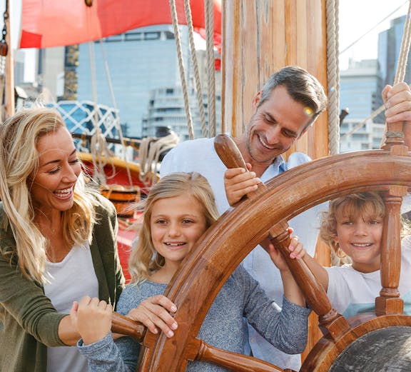Family enjoying interactive exhibit at Sydney's National Maritime Museum.