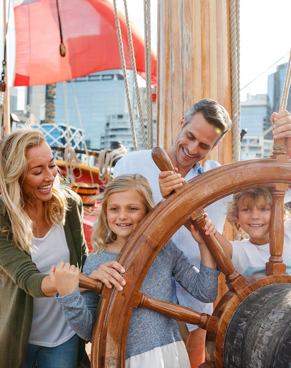 Family enjoying interactive exhibit at Sydney's National Maritime Museum.