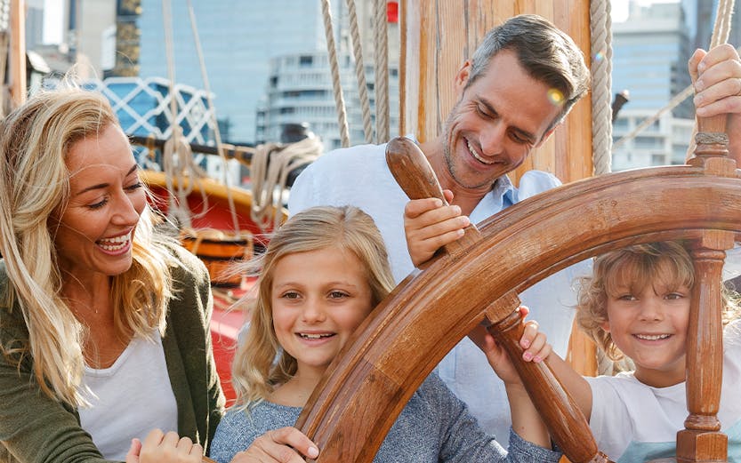 Family enjoying interactive exhibit at Sydney's National Maritime Museum.