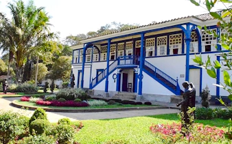 Historic plantation house with blue accents in Coffee Valley, Rio de Janeiro.