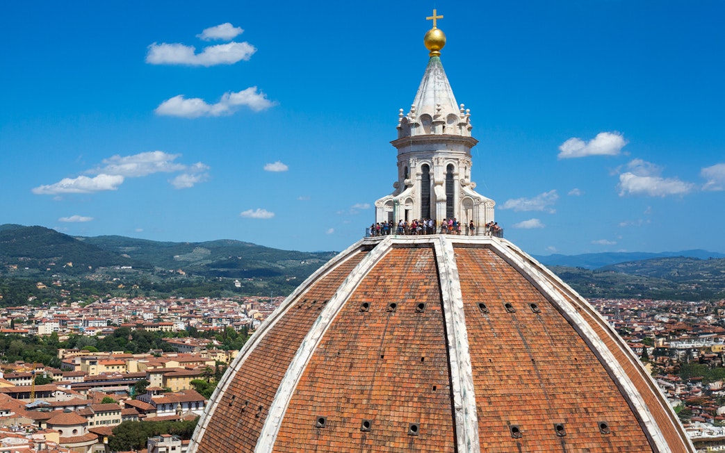 Brunelleschi's dome atop Florence Cathedral with cityscape in the background.