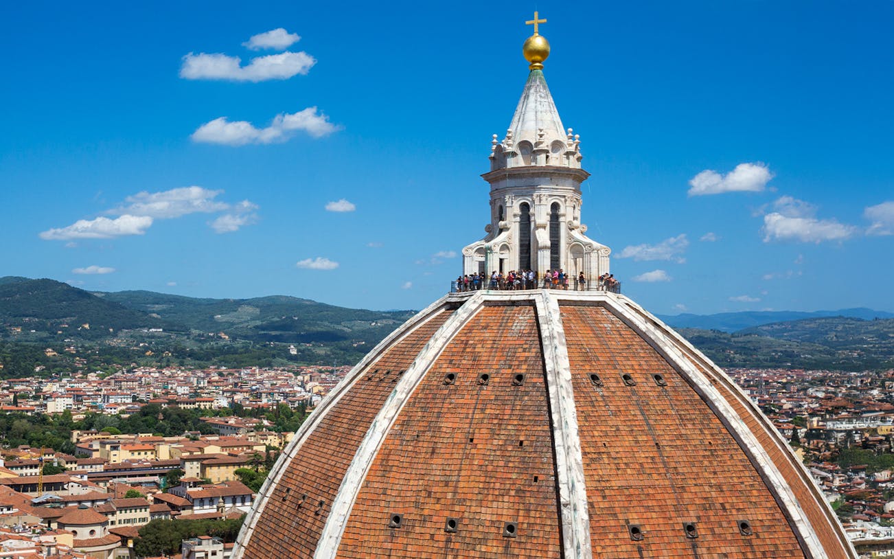 Brunelleschi's dome atop Florence Cathedral with cityscape in the background.