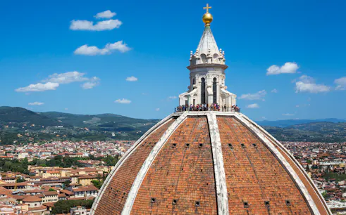 Brunelleschi's dome atop Florence Cathedral with cityscape in the background.