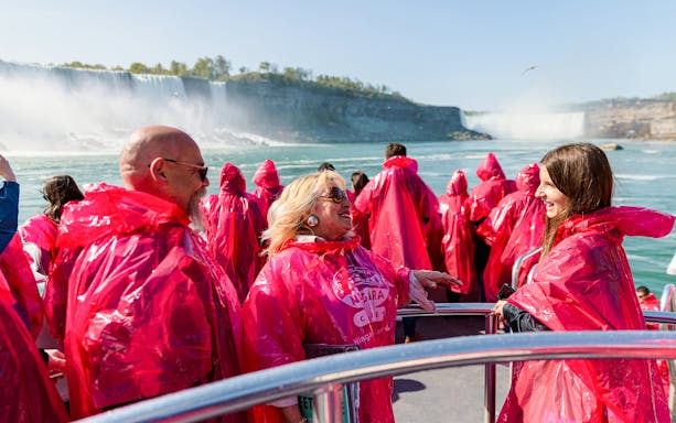 Tourists in red ponchos enjoying a boat ride near Niagara Falls.