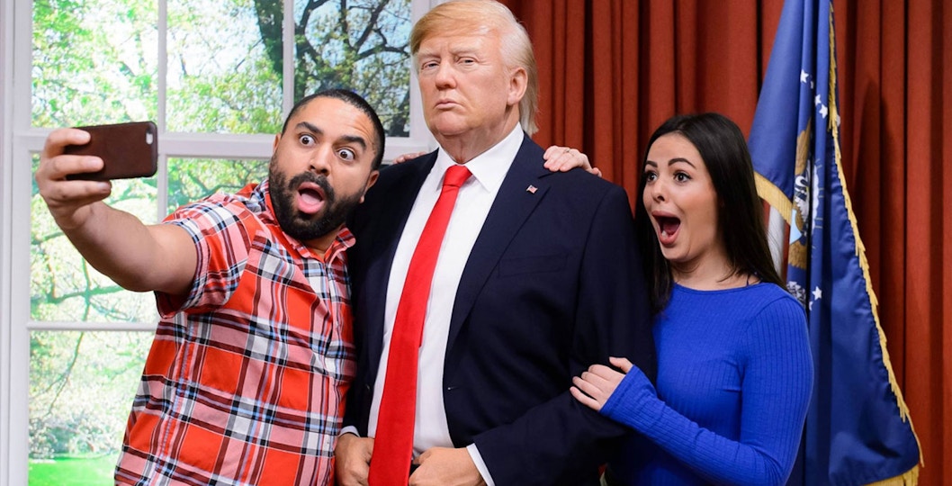 Visitors taking a selfie with a wax figure at Madame Tussauds Hong Kong.