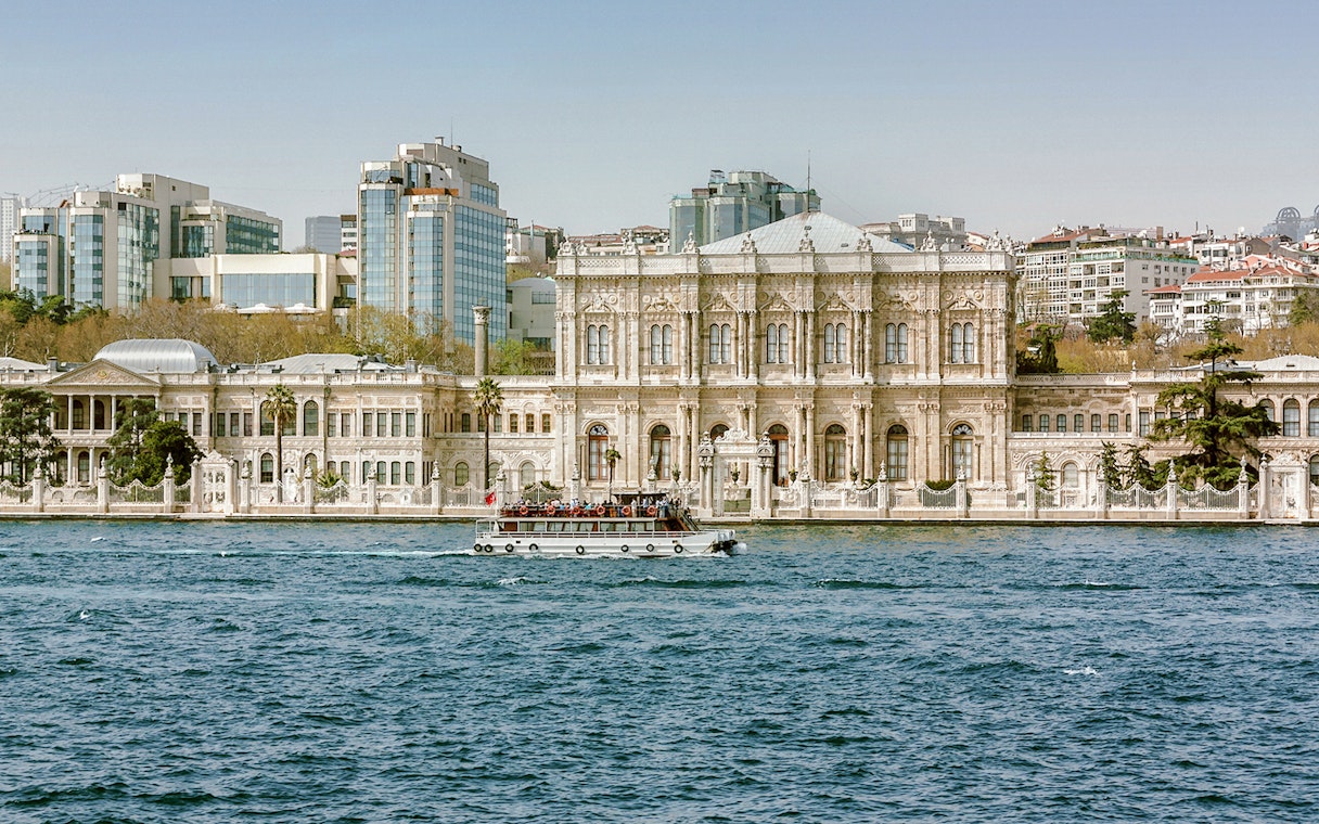 Dolmabahçe Palace in Istanbul with a boat on the Bosphorus.