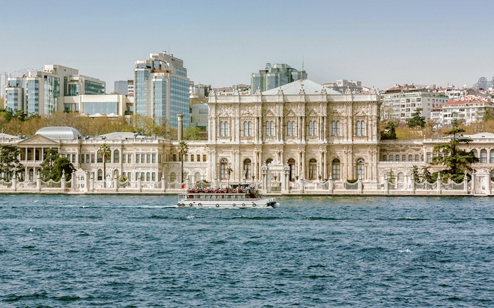Dolmabahçe Palace in Istanbul with a boat on the Bosphorus.