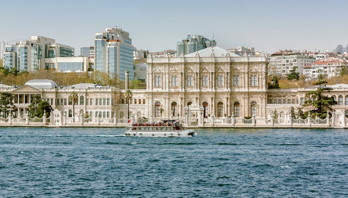 Dolmabahçe Palace in Istanbul with ornate architecture and Bosphorus view.