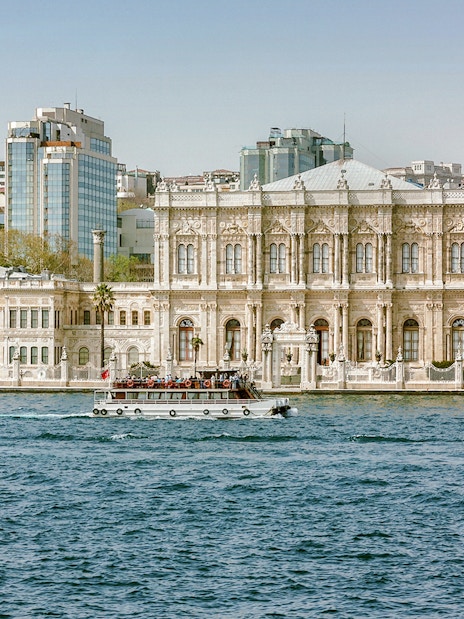 Dolmabahçe Palace in Istanbul with a boat on the Bosphorus.