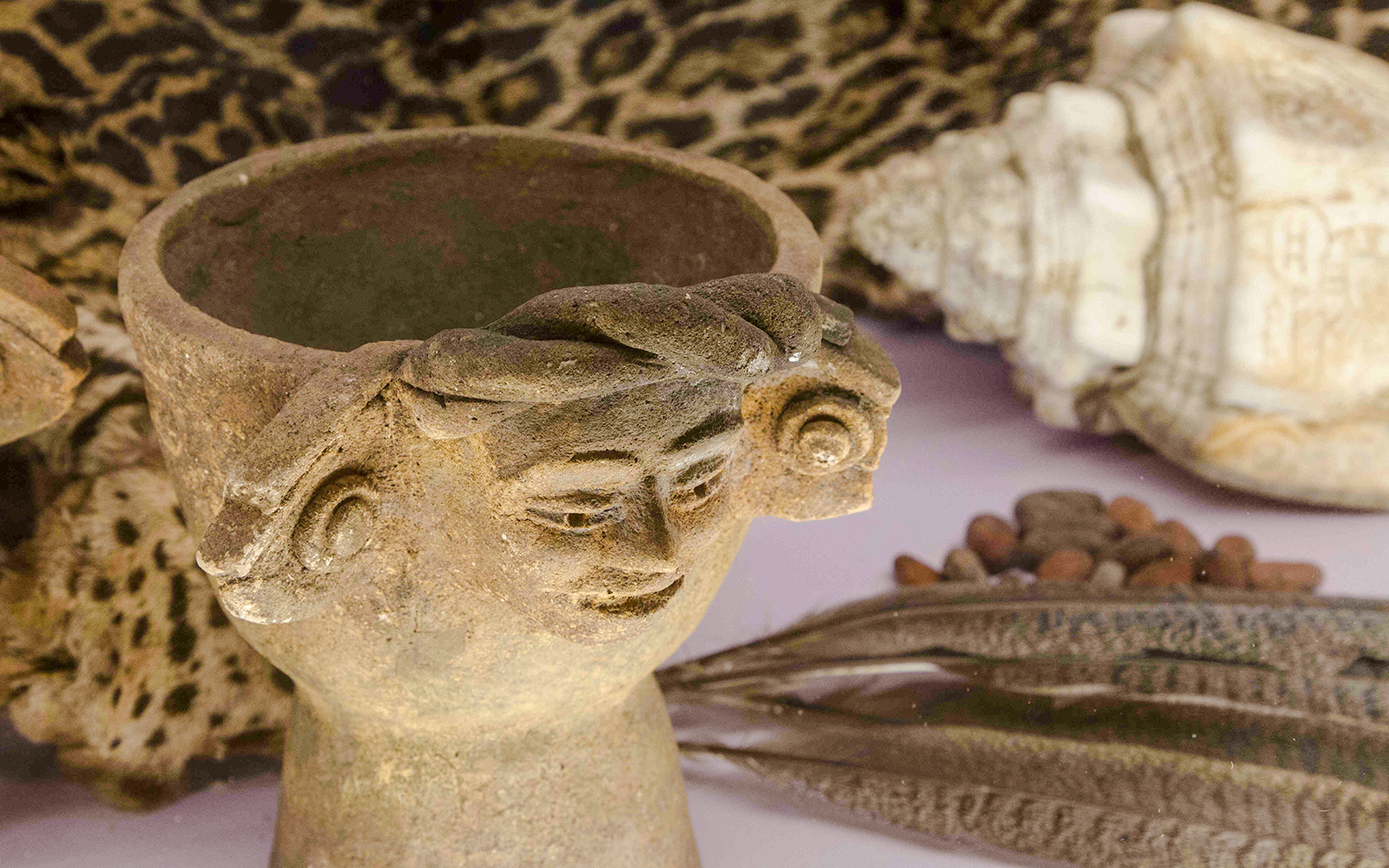 Ancient artifact with carved face in Chocolate Museum Paris exhibit.