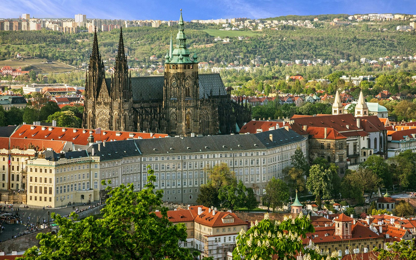 Prague Castle exterior with tourists exploring the historic architecture.