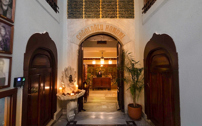 Entrance to Cagaloglu Hammam with ornate archway and reception desk.
