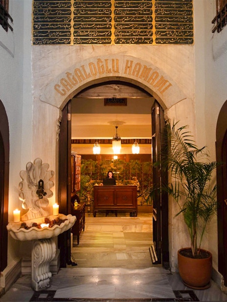 Entrance to Cagaloglu Hammam with ornate archway and reception desk.