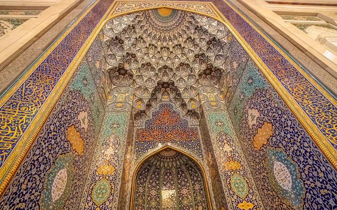 Mihrab with intricate tilework in Sultan Qaboos Grand Mosque, Oman.