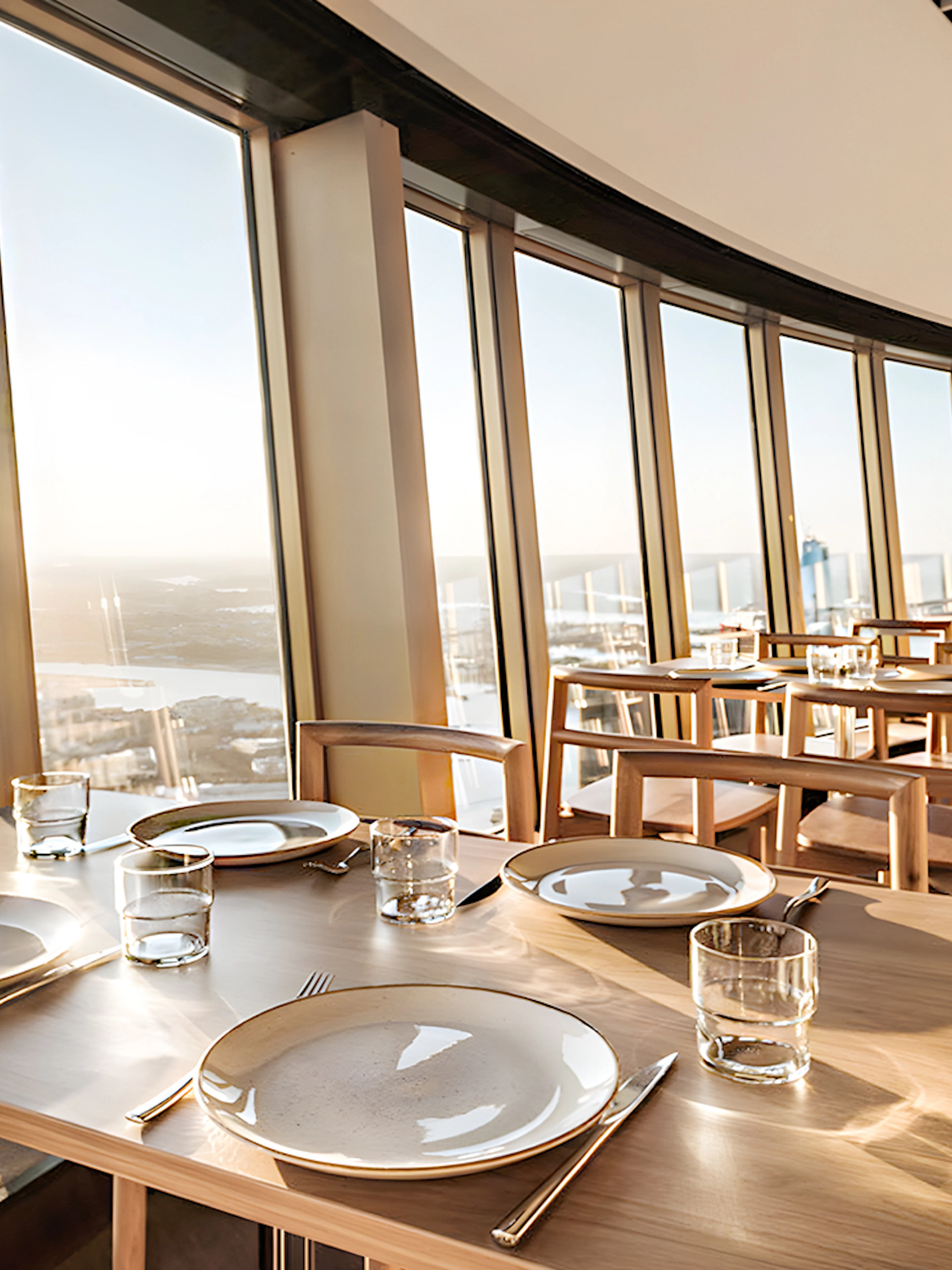 Dining tables set at SkyFeast, Sydney Tower, with panoramic city views.
