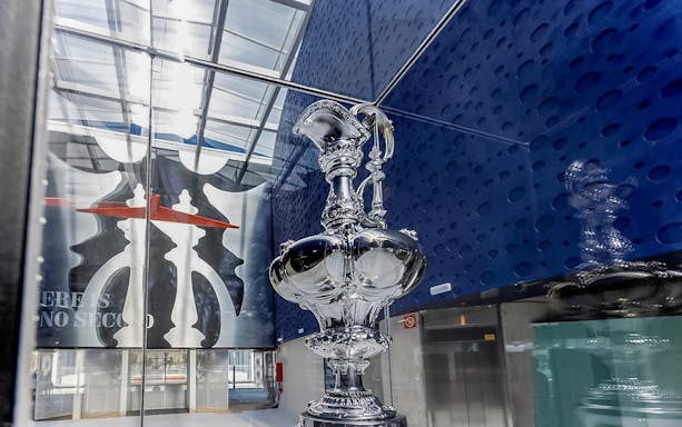 Silver trophy displayed in a glass case at Barcelona America's Cup Sailing Experience.
