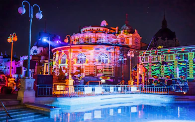 Colorful lights illuminate the Széchenyi Thermal Bath during a Sparty in Budapest.