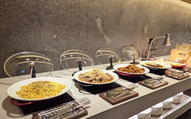 Buffet spread at Skyhub Lounge, Terminal 1, Incheon Airport, featuring various hot dishes.