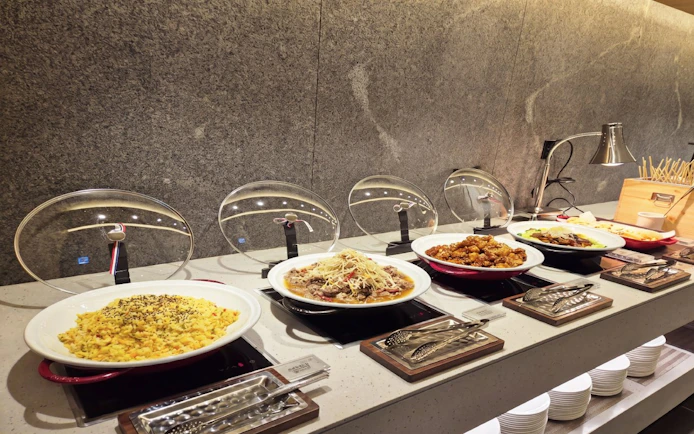 Buffet spread at Skyhub Lounge, Terminal 1, Incheon Airport, featuring various hot dishes.