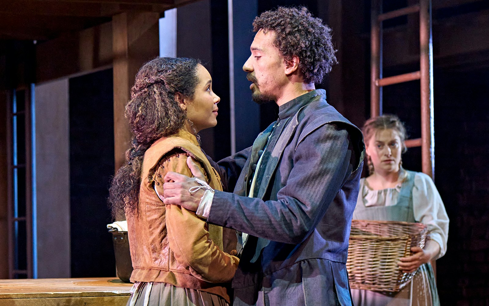 Actors performing a scene from "Hamnet" on stage.