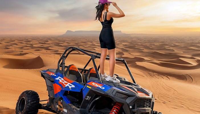 A woman standing on a quad bike