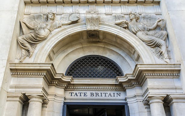 Tate Britain entrance with classical sculptures, London.