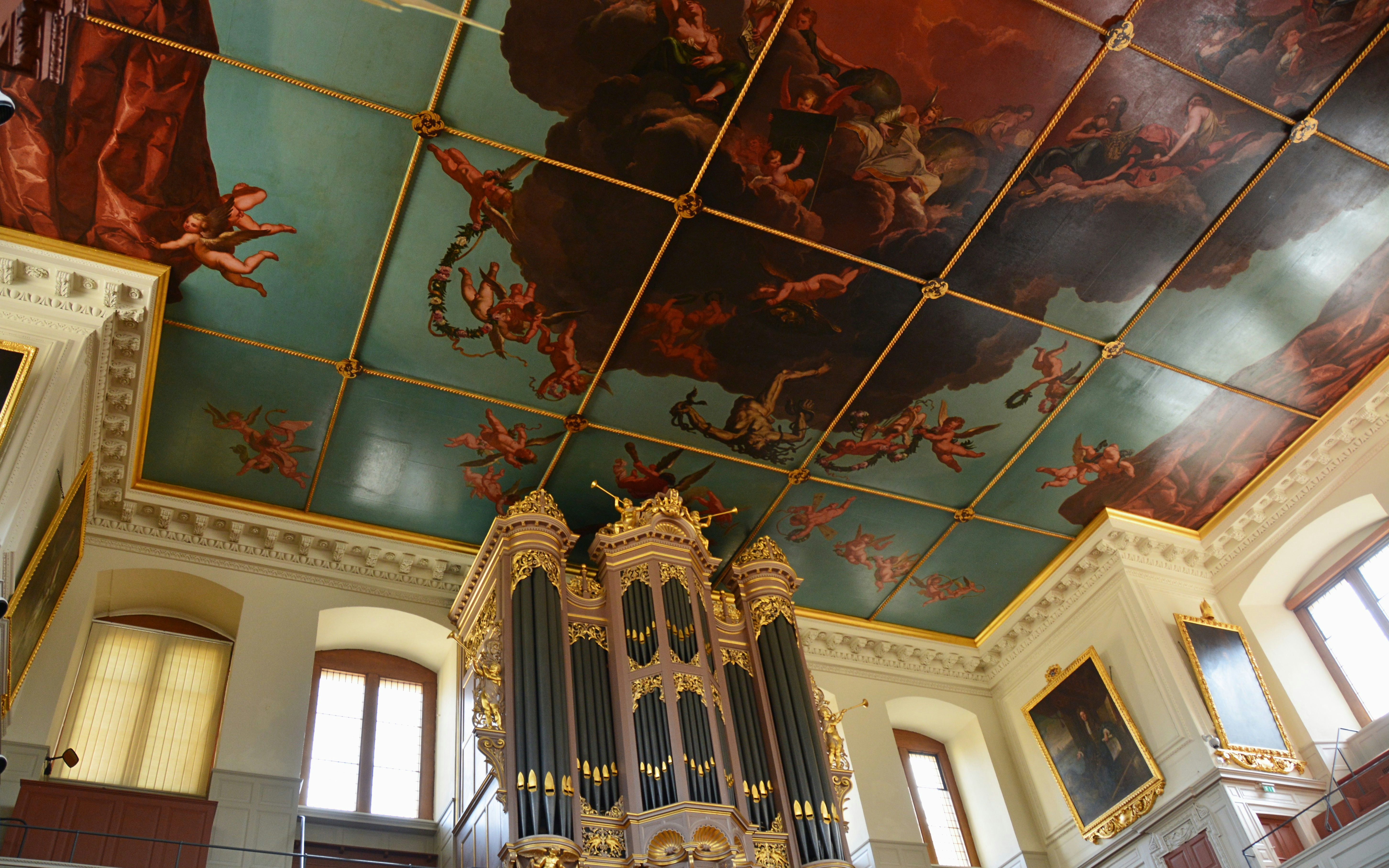 Sheldonian Theatre Oxford ceiling with painted cherubs and ornate organ.