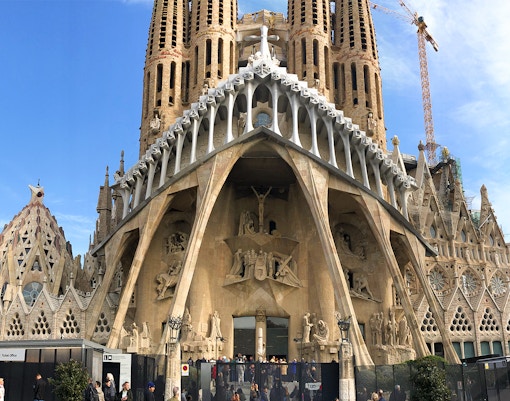 Sagrada Familia facade with visitors at entrance, Barcelona.