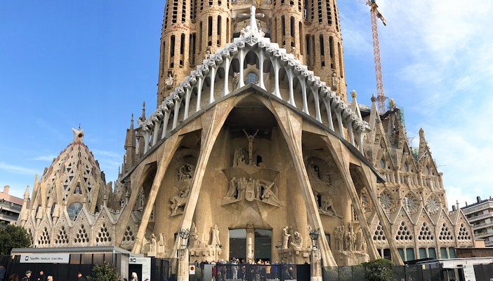 Sagrada Familia facade with visitors at entrance, Barcelona.