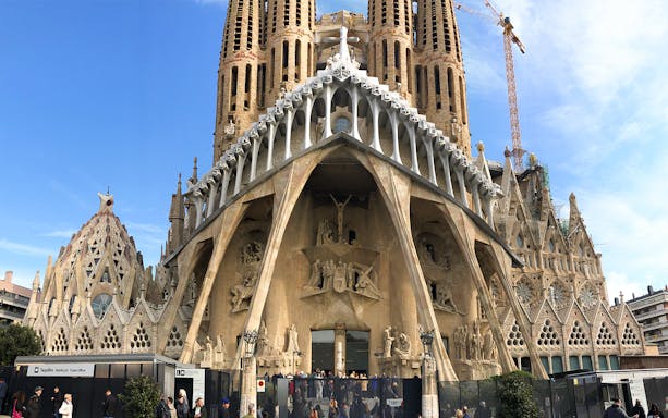 Sagrada Familia facade with visitors at entrance, Barcelona.