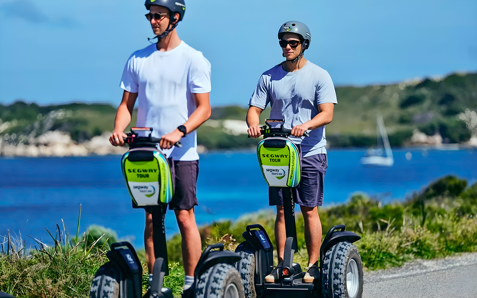Tourist riding a Segway on Rottnest Island path with scenic coastal view in Perth, Australia.