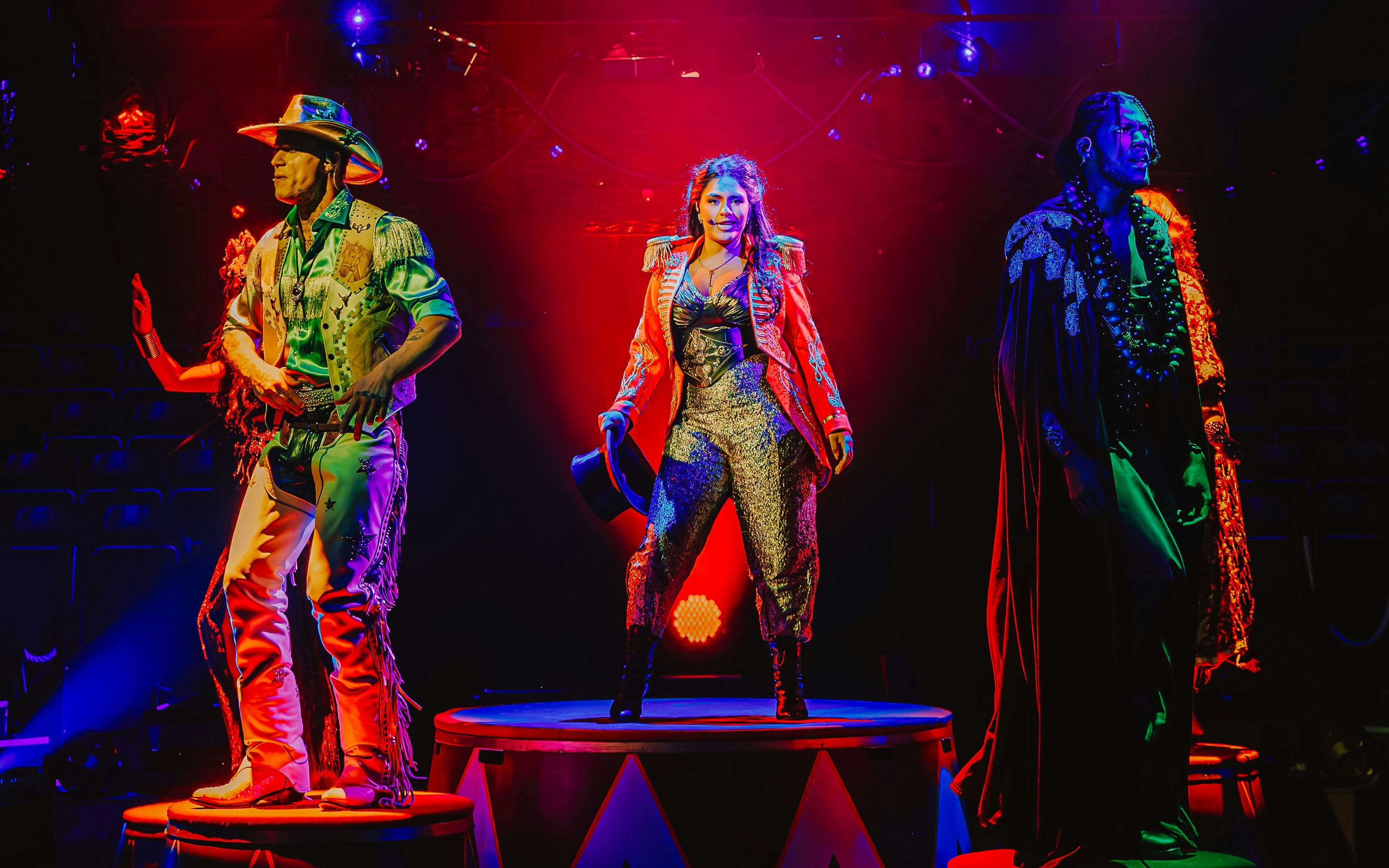 Performers on stage during Come Alive Westend show, featuring vibrant costumes and dramatic lighting.