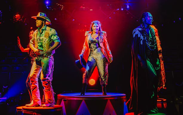 Performers on stage during Come Alive Westend show, featuring vibrant costumes and dramatic lighting.