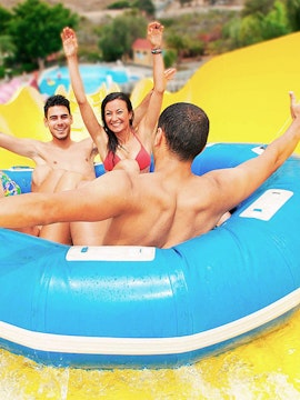 Visitors enjoying a water slide ride at Aqualand Maspalomas.