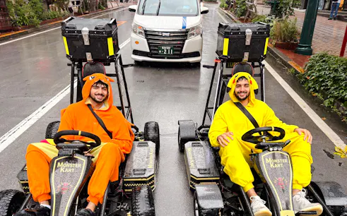 Tourists in character costumes driving go-karts on a Tokyo street during Asakusa Electric Go Kart 90 min Tour.