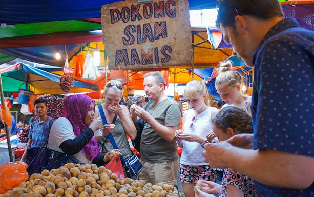 Street food vendors in Kuala Lumpur serving traditional Malaysian dishes on the Flavours of Malaysia Food Tour.