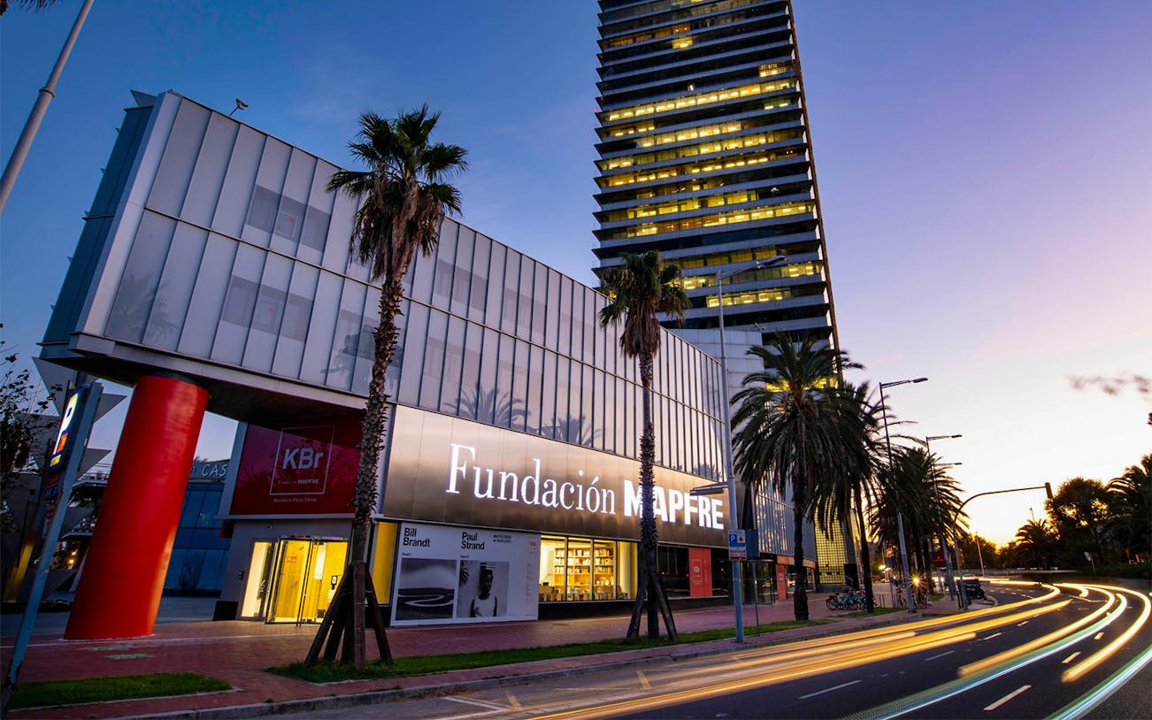 Fundación MAPFRE building exterior at dusk, Barcelona, with KBr Photography Center signage.