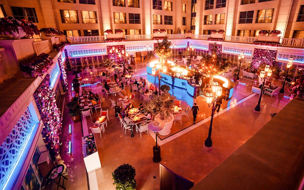 Dining area at Le Patio Restaurant, Dubai, with guests enjoying meals under ambient lighting.