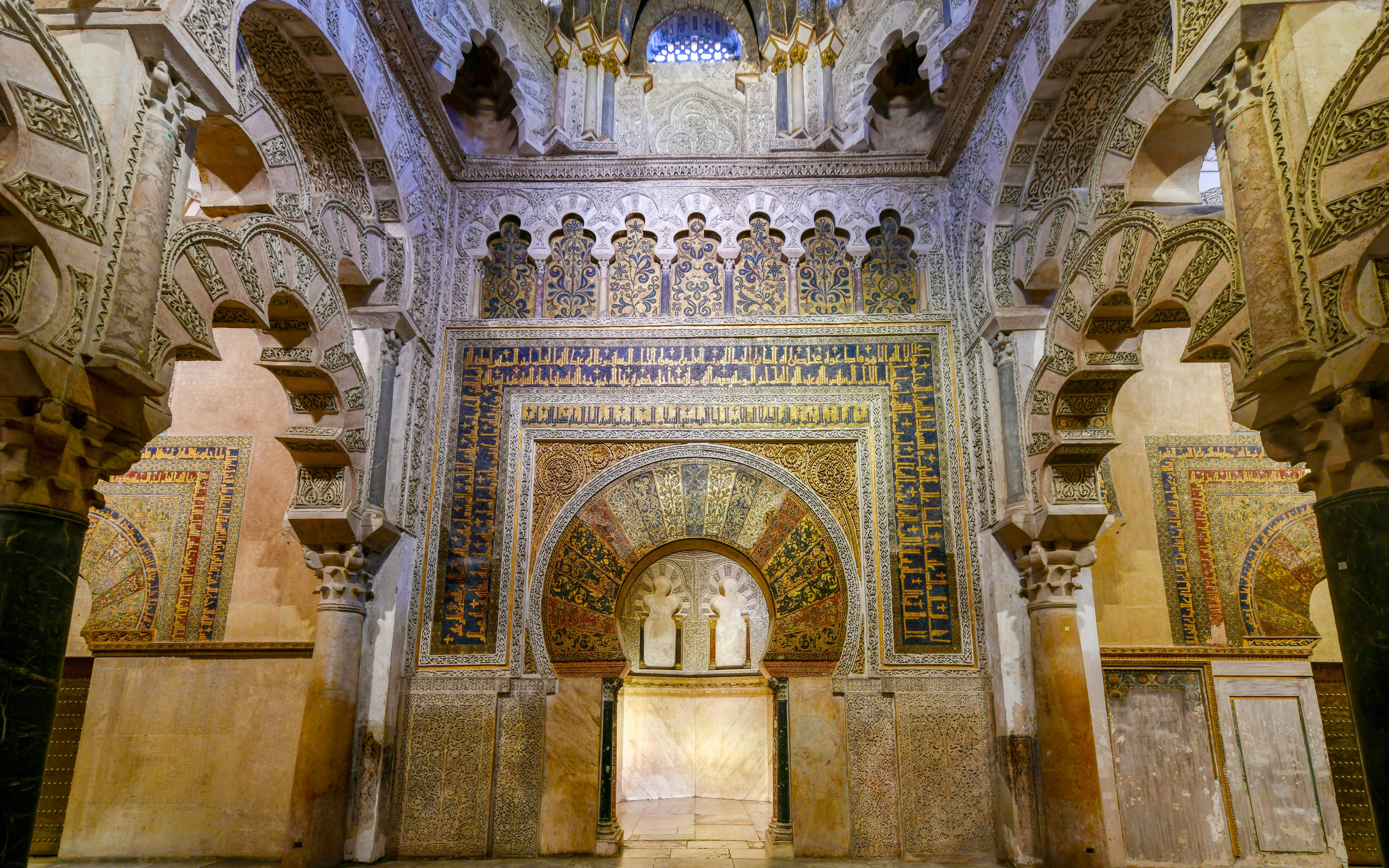 Mihrab of the Great Mosque of Cordoba with intricate arches and detailed mosaics.